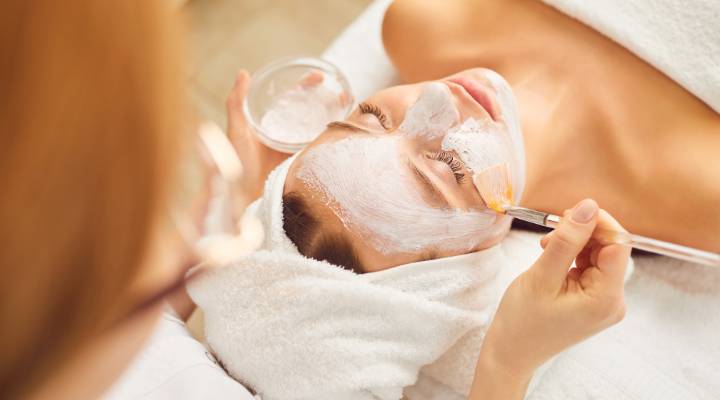 moça aplicando mascara de argila branca no rosto