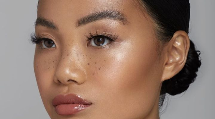 Mulher com maquiagem leve e sardas no rosto